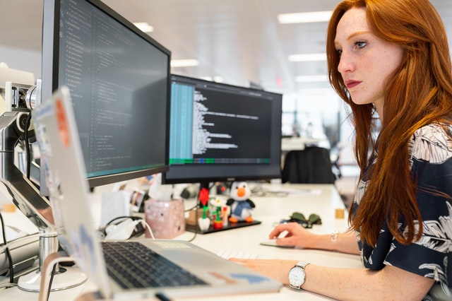 employee with red hair working on computer